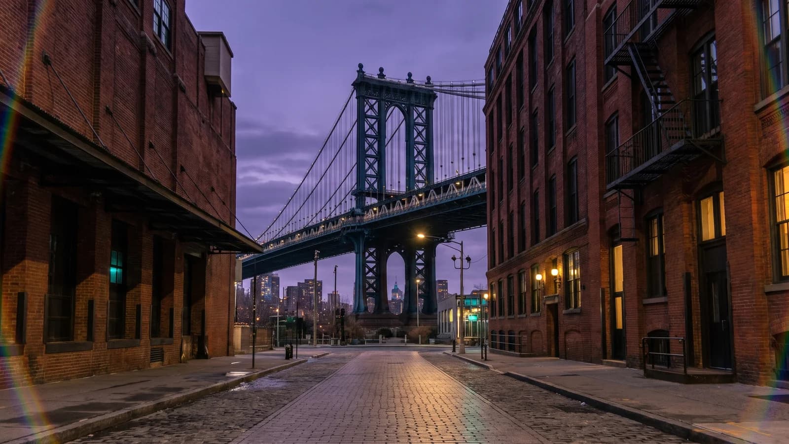 AI-generated view along a DUMBO street toward the Manhattan Bridge in amethyst twilight