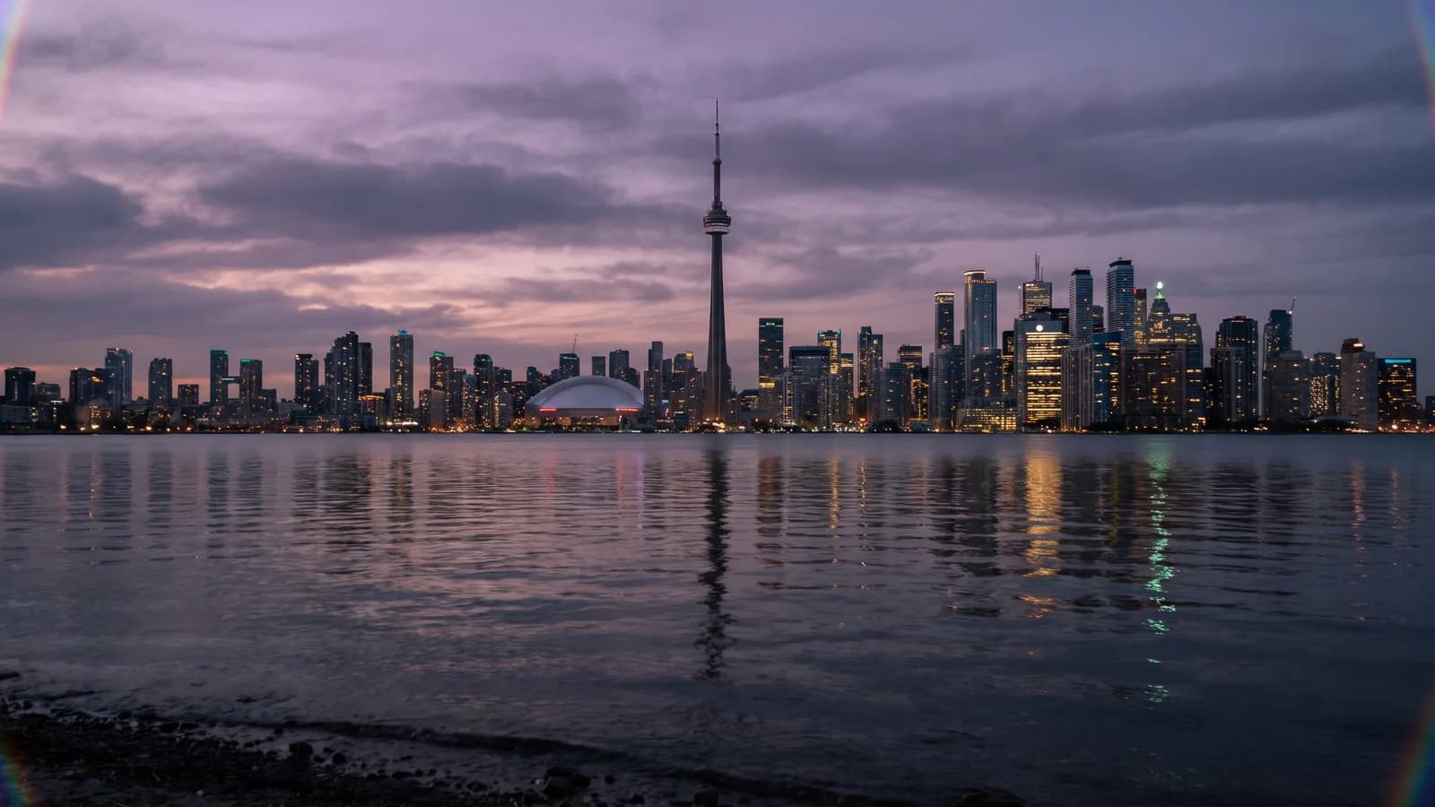 AI-generated Toronto city portrait with the CN Tower, amethyst dusk, and gold harbour reflections