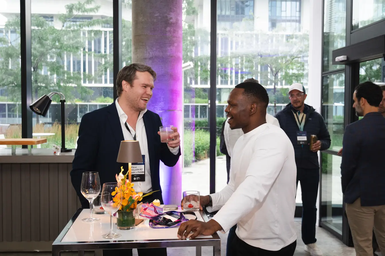 Dico Angelo in conversation at a networking reception