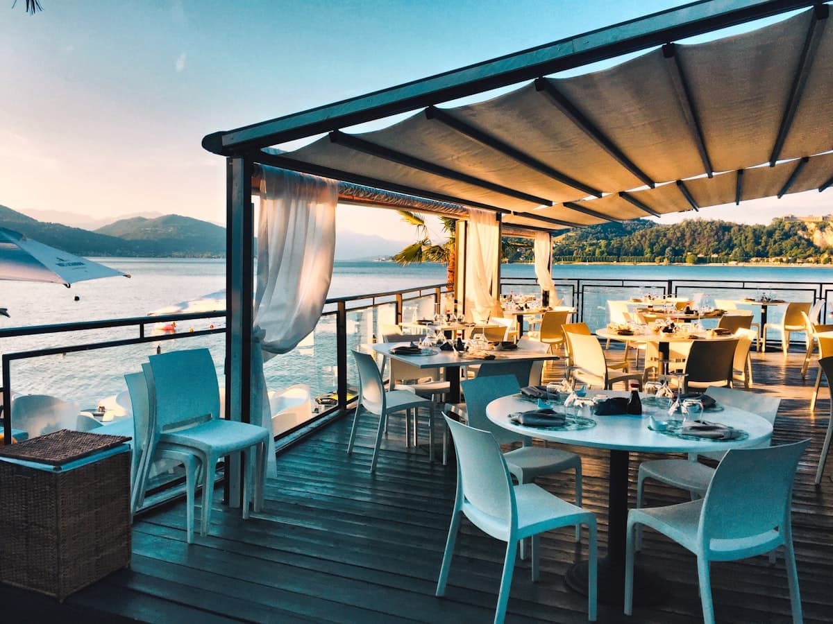 An open-air dining terrace beside the water